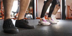 side-view-people-exercising-together-gym-shoes