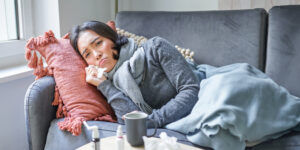 sick-woman-lying-sofa-home-catching-cold-young-girl-freezing-from-heating-problem-her