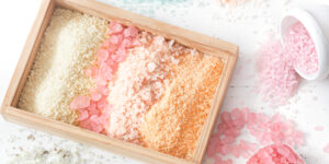 multicolored-sea-salt-box-white-background-top-view-flat-lay